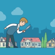 Ein großer Mann schaut mit einer Lupe auf kleine Häuser | Immobilienwertermittlung